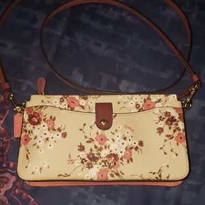 A brand new coach cross body wallet